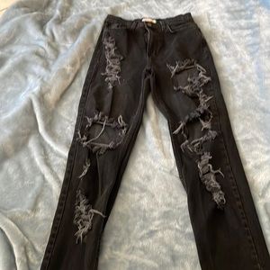 Distressed denim jeans.